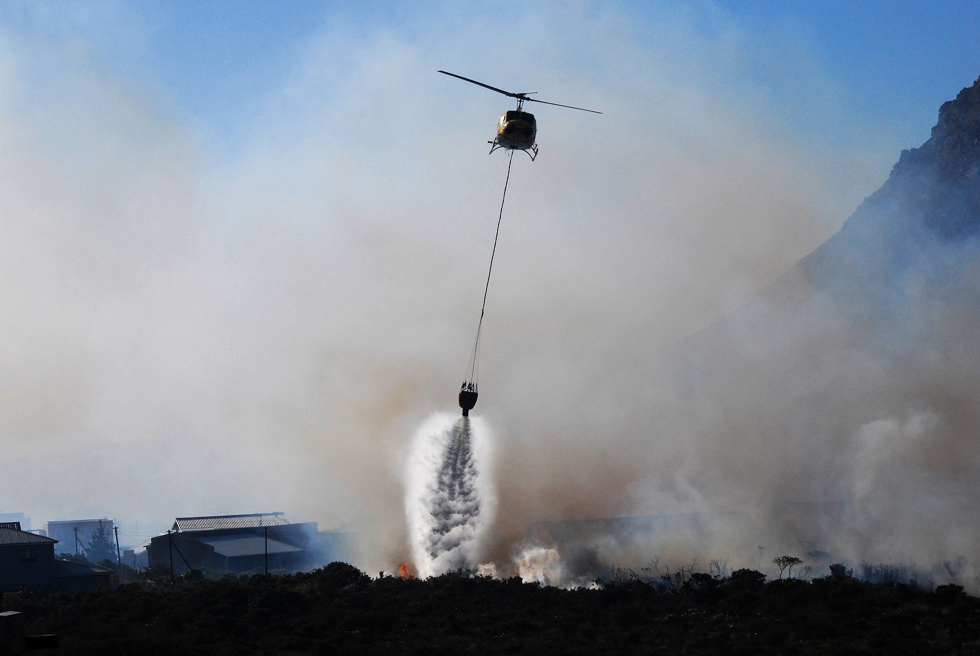 Wildfire Doused with Water from Helicopter